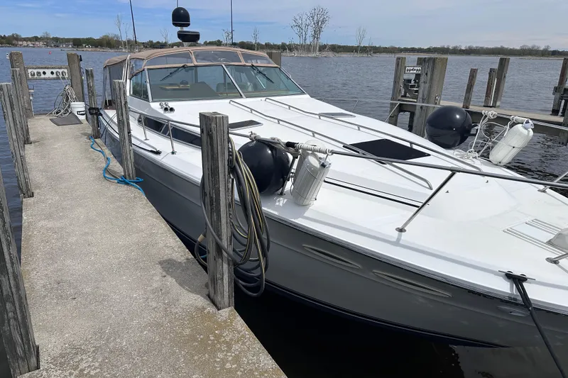 Slide: The Image of 1989 Sea Ray 390 Express Cruiser docked at a marina. - 4