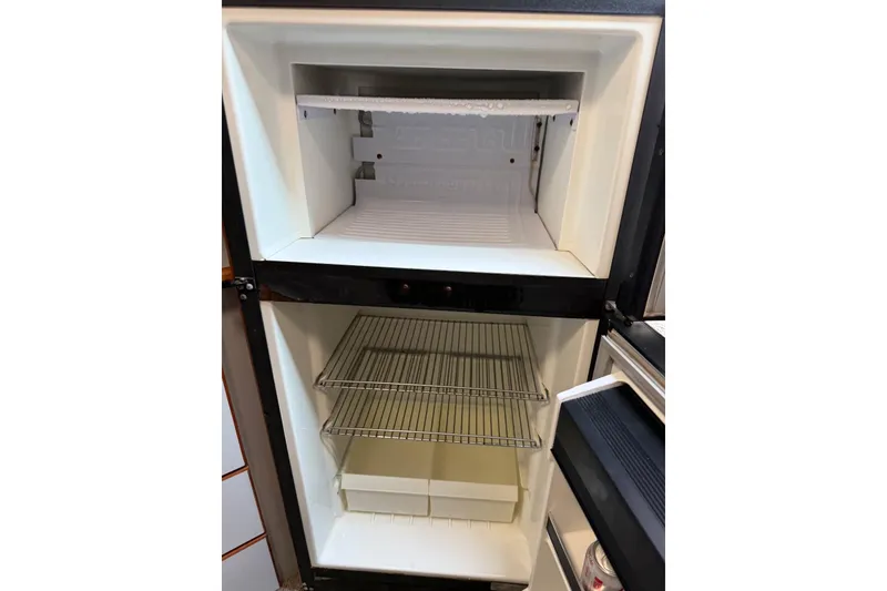 Slide: The Image of Empty refrigerator inside 1989 Sea Ray 390 Express Cruiser boat. - 41