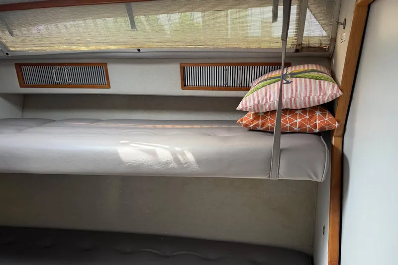 Slide: The Image of Interior cabin of 1989 Sea Ray 390 Express Cruiser with bunk bed and colorful pillows. - 43