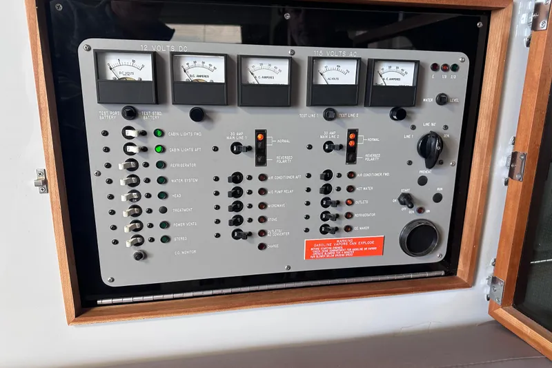 Slide: The Image of Control panel of a 1989 Sea Ray 390 Express Cruiser with various switches and gauges. - 44