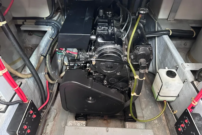 Slide: The Image of Engine compartment of a 1989 Sea Ray 390 Express Cruiser, showcasing mechanical components and wiring. - 47