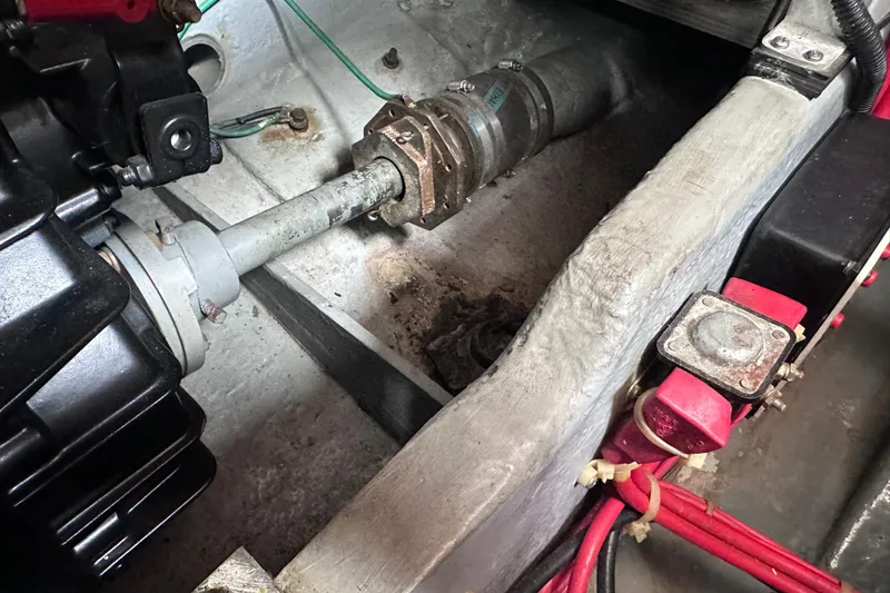 Slide: The Image of Engine compartment of a 1989 Sea Ray 390 Express Cruiser, showing mechanical components and wiring. - 48