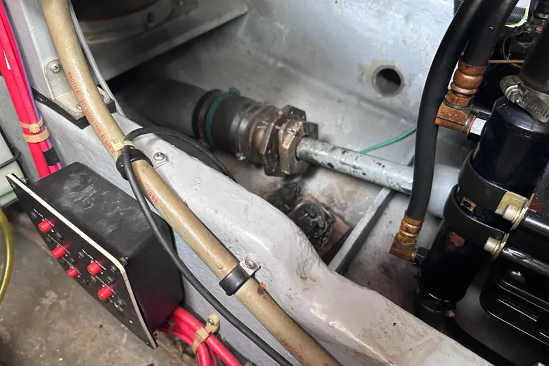 Slide: The Image of Engine compartment of a 1989 Sea Ray 390 Express Cruiser, showing mechanical components and wiring. - 49