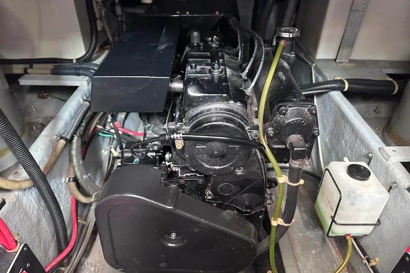 Slide: The Image of Engine compartment of a 1989 Sea Ray 390 Express Cruiser, showing detailed mechanical components. - 50