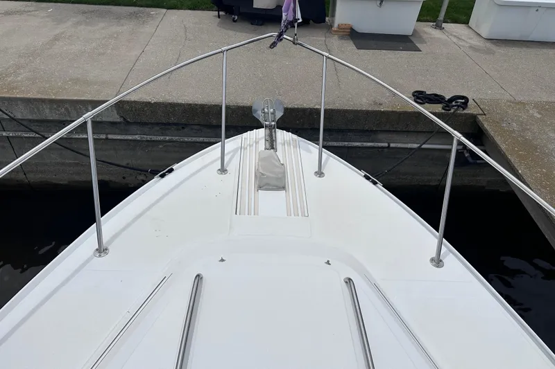 Slide: The Image of Bow view of 1989 Sea Ray 390 Express Cruiser docked at marina. - 9