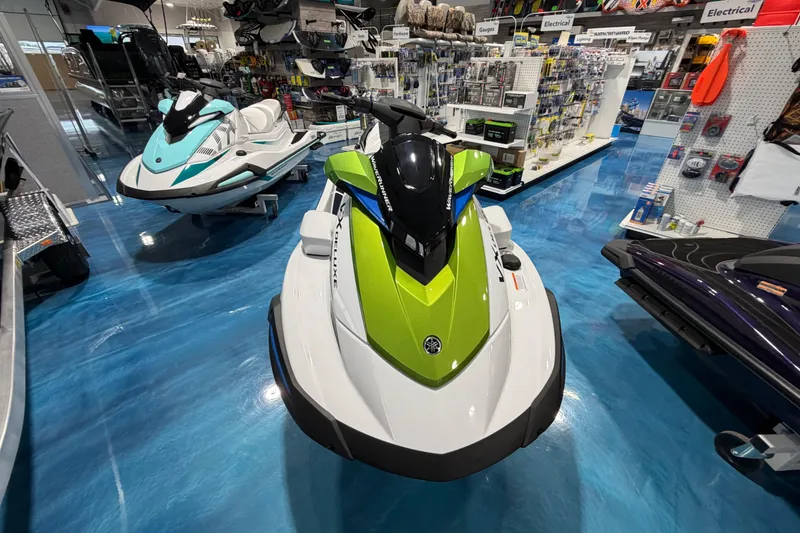 Slide: The Image of 2026 Yamaha WaveRunner VX Deluxe in showroom, featuring sleek design and vibrant colors. - 2