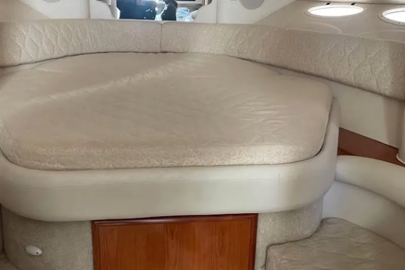 Slide: The Image of Interior cabin of 2001 Sea Ray 340 Sundancer with beige upholstery and wooden accents. - 4