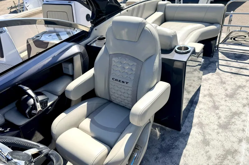 Slide: The Image of Luxury seating on 2022 Crest Continental 270 NX-CS Twin boat, featuring plush upholstery and modern design. - 10