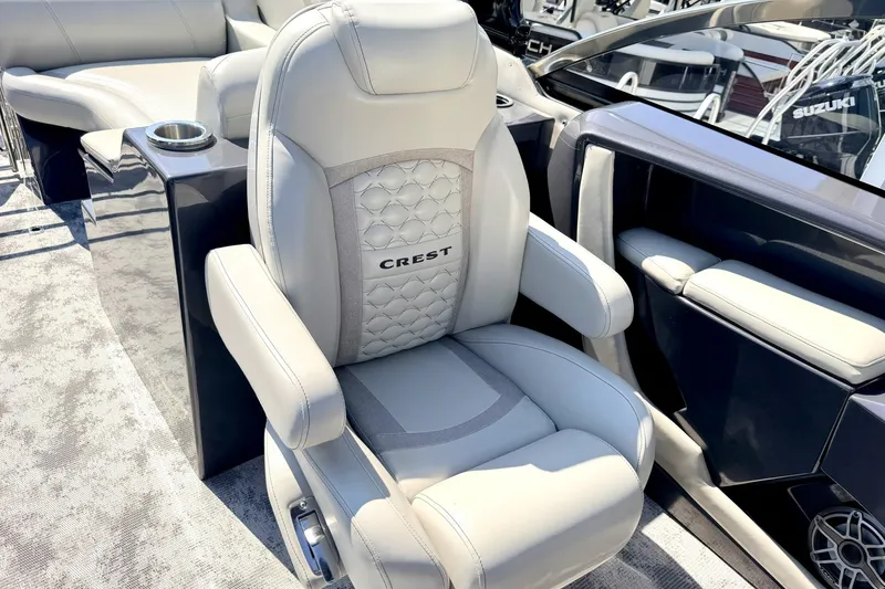 Slide: The Image of Luxury seating on 2022 Crest Continental 270 NX-CS Twin boat, featuring plush upholstery and armrests. - 11