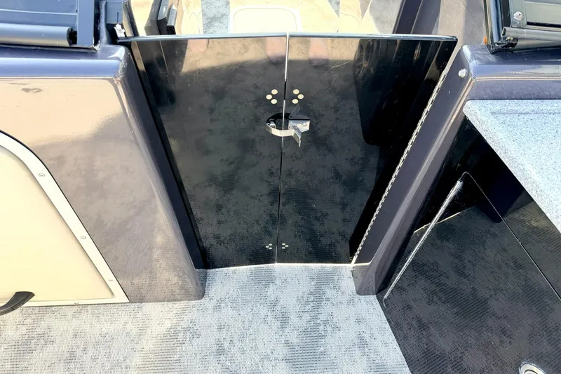 Slide: The Image of 2022 Crest Continental 270 NX-CS Twin boat interior with sleek black door and modern design. - 16