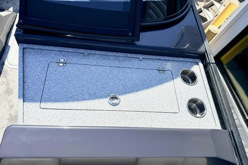 Slide: The Image of 2022 Crest Continental 270 NX-CS Twin boat console with storage compartment and cup holders. - 19