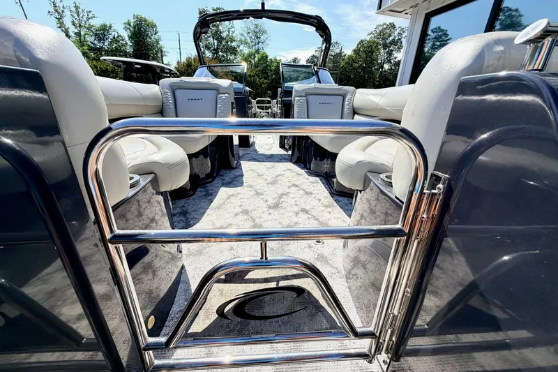 Slide: The Image of 2022 Crest Continental 270 NX-CS Twin pontoon boat interior with luxurious seating and sleek design. - 22