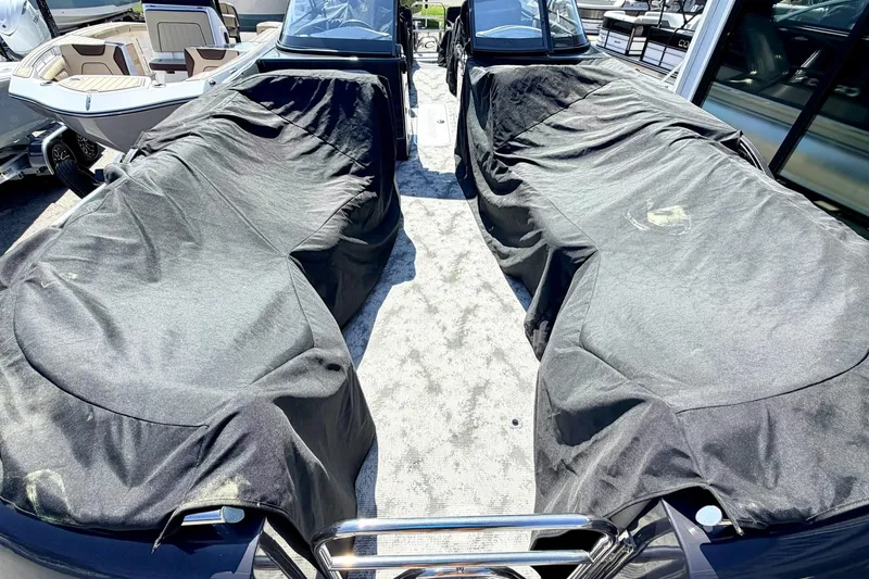 Slide: The Image of 2022 Crest Continental 270 NX-CS Twin boat with protective covers in a showroom. - 25
