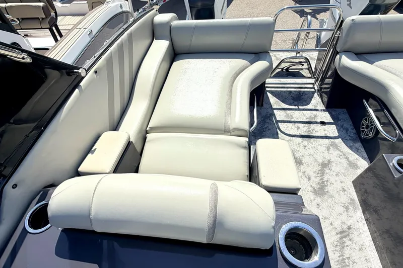 Slide: The Image of Luxurious seating on 2022 Crest Continental 270 NX-CS Twin boat, featuring plush upholstery and cup holders. - 5