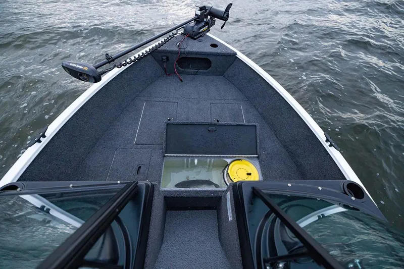 Slide: The Image of Manufacturer Provided Image: 2026 Crestliner 1650 Kodiak WT boat interior with open storage compartment on water. - 16