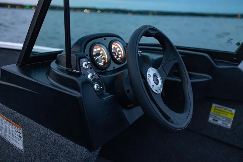 Slide: The Image of Manufacturer Provided Image: Steering console of 2026 Crestliner 1650 Kodiak WT boat at dusk on water. - 19