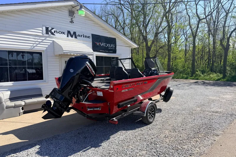 Slide: The Image of 2026 Crestliner 1650 Kodiak WT boat in red, parked outside Knox Marine. - 2