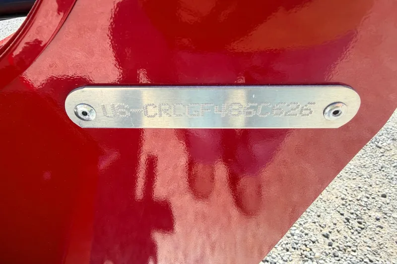 Slide: The Image of 2026 Crestliner 1650 Kodiak WT boat identification plate on red surface. - 4
