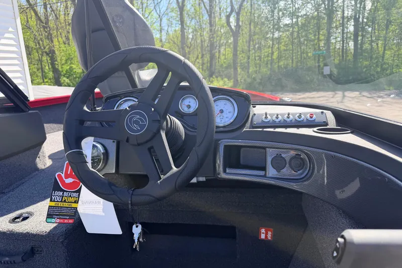 Slide: The Image of 2026 Crestliner 1650 Kodiak WT dashboard with steering wheel and gauges in sunlight. - 5