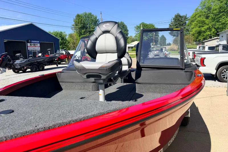 Slide: The Image of 2026 Crestliner 1650 Kodiak WT boat with red exterior and comfortable seating. - 7
