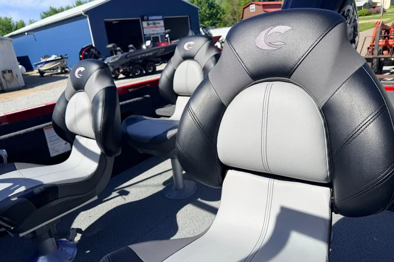 Slide: The Image of 2026 Crestliner 1650 Kodiak WT boat seats, black and gray, in a sunny outdoor setting. - 8