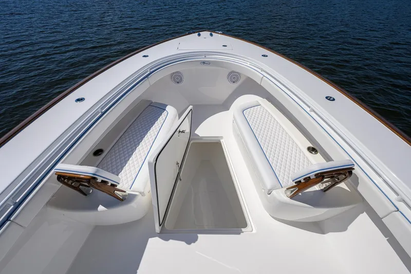 Slide: The Image of 2025 Valhalla Boatworks V-41 bow seating area with storage compartment, on calm water. - 12