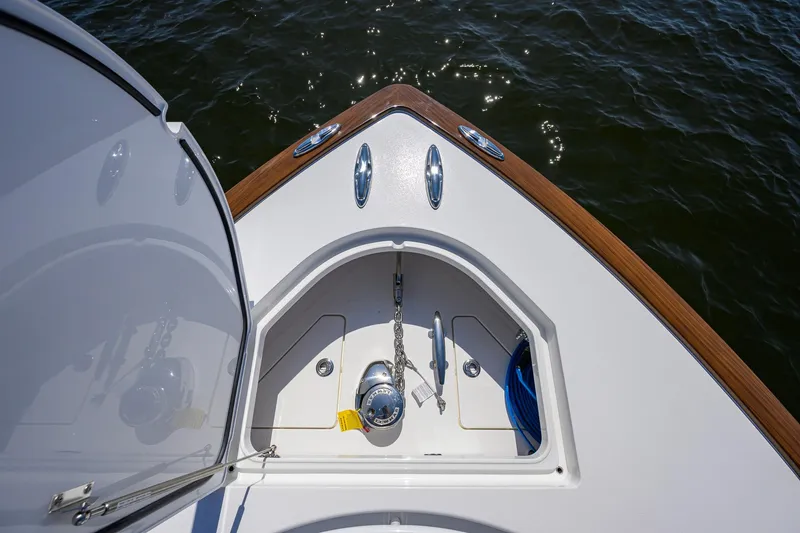 Slide: The Image of 2025 Valhalla Boatworks V-41 bow with anchor storage, wooden trim, and ocean view. - 15
