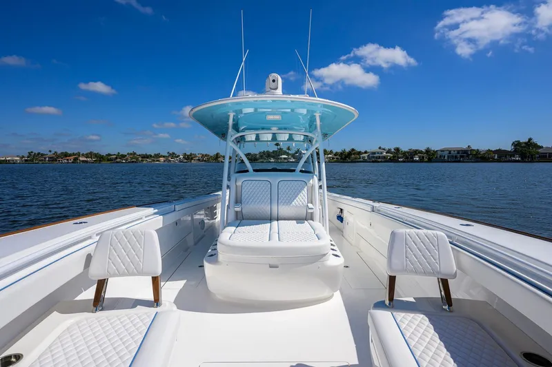 Slide: The Image of 2025 Valhalla Boatworks V-41 on calm water, featuring sleek design and luxurious seating. - 17
