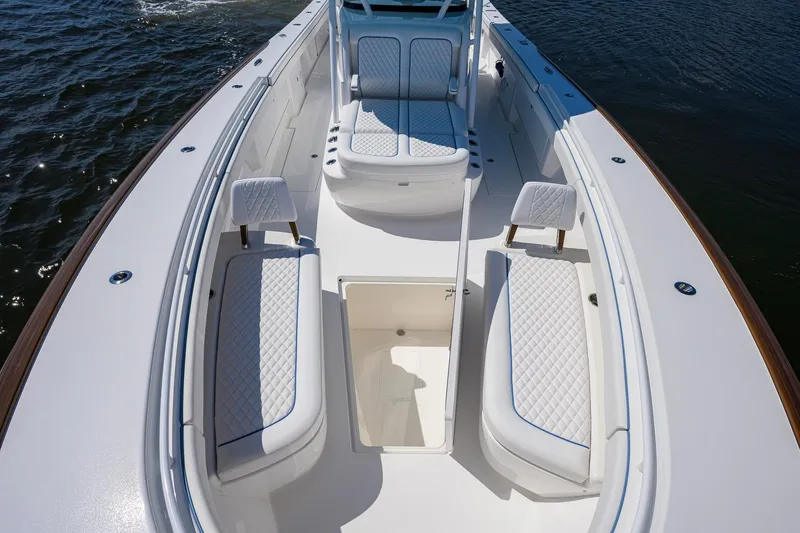 Slide: The Image of 2025 Valhalla Boatworks V-41 interior with white seating and storage compartments. - 18