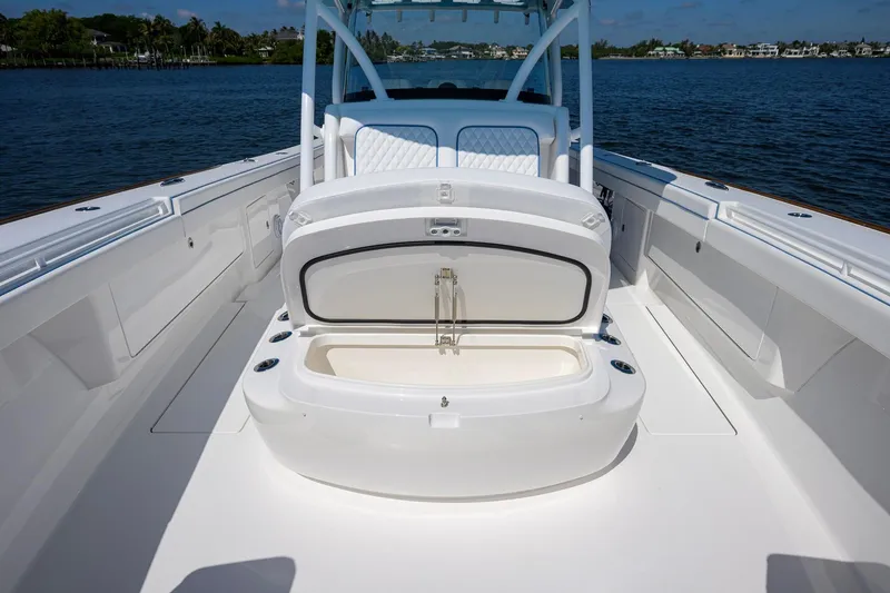 Slide: The Image of 2025 Valhalla Boatworks V-41 deck with open storage compartment, on calm water. - 19