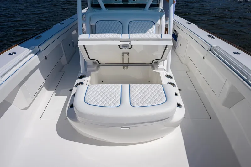 Slide: The Image of 2025 Valhalla Boatworks V-41 interior with open storage compartment, featuring quilted seating. - 20