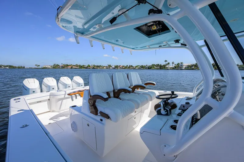 Slide: The Image of 2025 Valhalla Boatworks V-41 interior with luxurious seating and advanced controls on a serene waterway. - 22