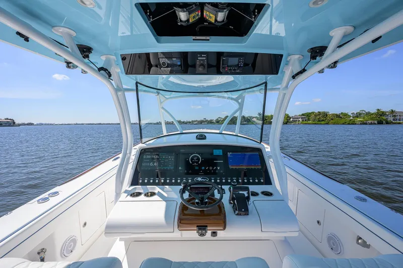 Slide: The Image of 2025 Valhalla Boatworks V-41 helm with advanced navigation system on open water. - 6