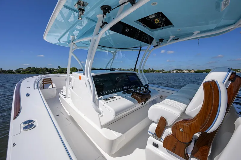 Slide: The Image of 2025 Valhalla Boatworks V-41 center console, luxurious seating, and advanced navigation system on a sunny day. - 7