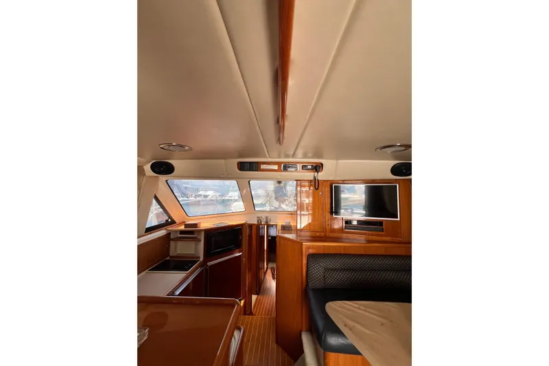 Slide: The Image of Interior of 2002 Riviera 54 Enclosed Flybridge with wood finish and modern amenities. - 11