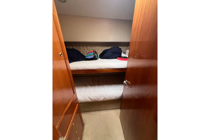 Slide: The Image of Cozy cabin with bunk beds in 2002 Riviera 54 Enclosed Flybridge yacht. - 23