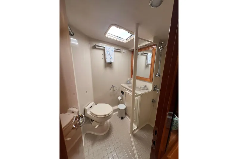Slide: The Image of Bathroom interior of 2002 Riviera 54 Enclosed Flybridge yacht, featuring shower and toilet. - 24