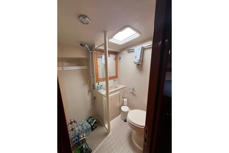 Slide: The Image of Bathroom interior of 2002 Riviera 54 Enclosed Flybridge yacht, featuring shower and toilet. - 25