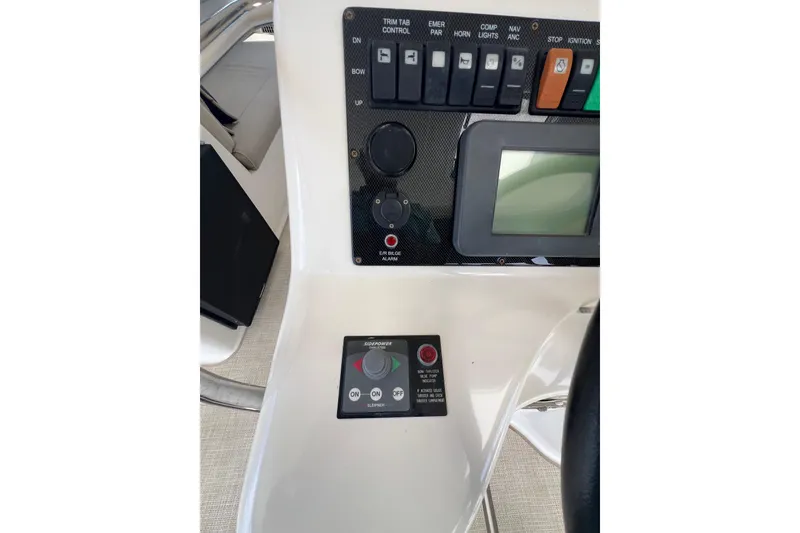 Slide: The Image of Control panel of 2002 Riviera 54 Enclosed Flybridge with various switches and display. - 27