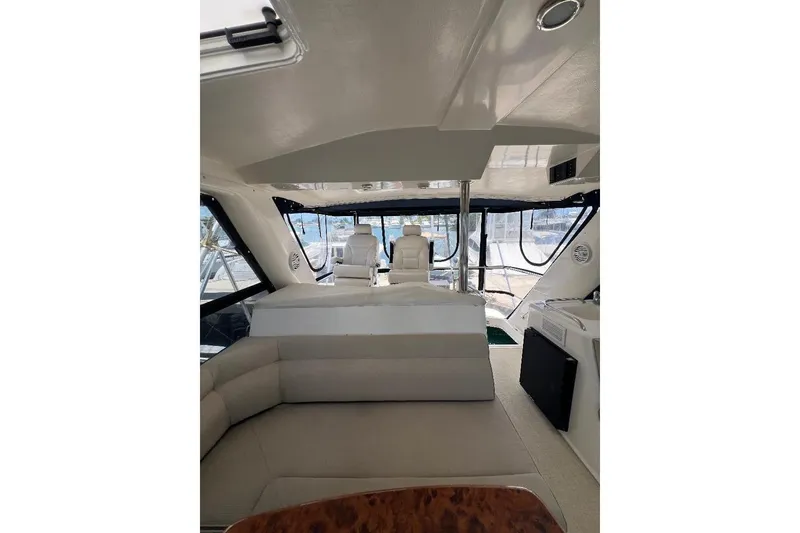 Slide: The Image of Interior view of 2002 Riviera 54 Enclosed Flybridge yacht with seating and helm. - 28