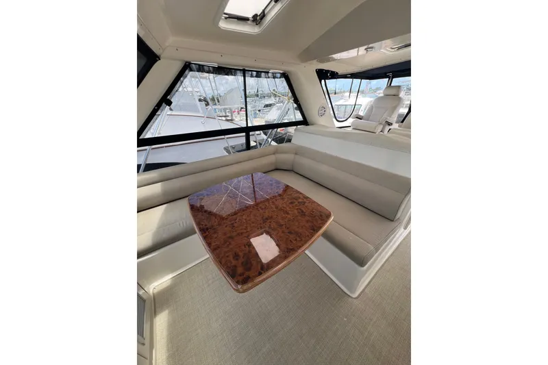 Slide: The Image of Luxurious interior of 2002 Riviera 54 Enclosed Flybridge with elegant seating and polished table. - 29