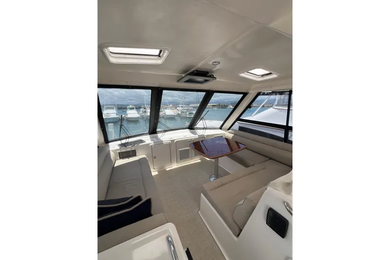 Slide: The Image of Interior of 2002 Riviera 54 Enclosed Flybridge yacht with seating and ocean view. - 30