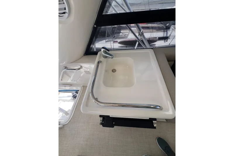 Slide: The Image of Sink area on 2002 Riviera 54 Enclosed Flybridge yacht, featuring modern fixtures and window view. - 33