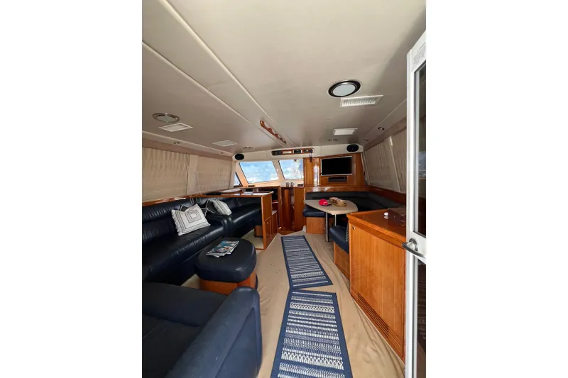 Slide: The Image of Luxurious interior of 2002 Riviera 54 Enclosed Flybridge yacht with leather seating and wood finishes. - 8
