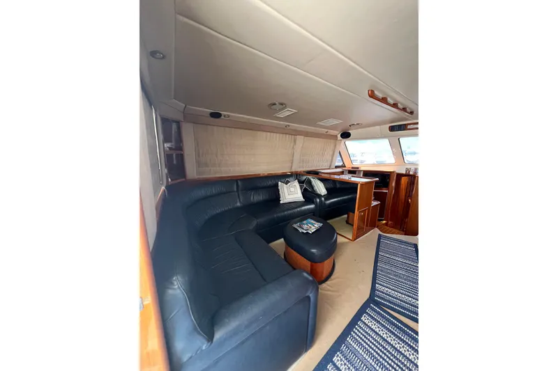Slide: The Image of Luxurious interior of 2002 Riviera 54 Enclosed Flybridge yacht with leather seating and wooden accents. - 9