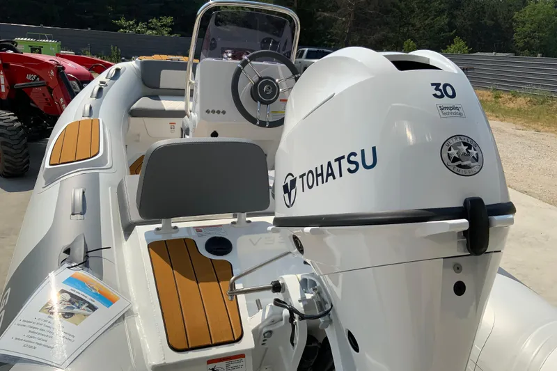 Slide: The Image of 2027 Gala V330 boat with Tohatsu engine, featuring sleek design and modern controls. - 10