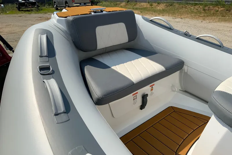 Slide: The Image of 2027 Gala V330 inflatable boat interior with cushioned seating and wooden flooring. - 6
