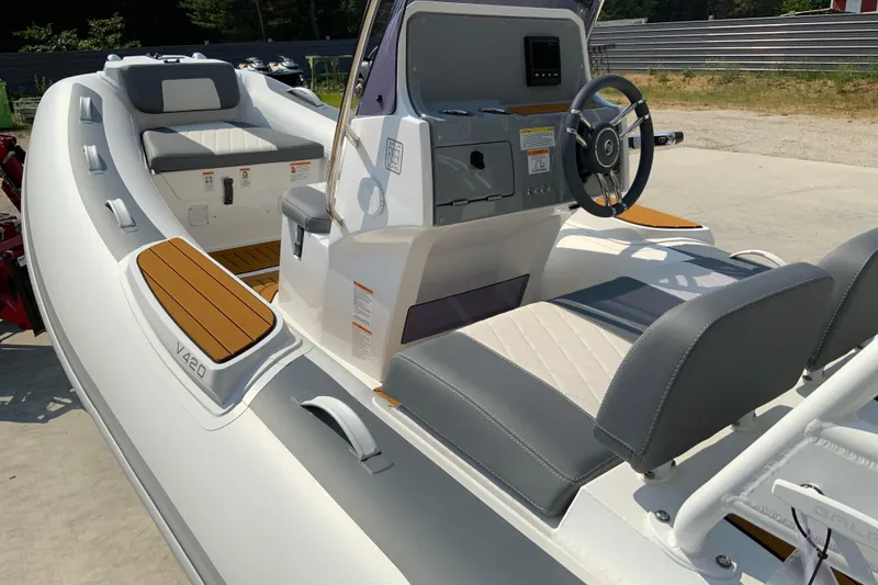 Slide: The Image of 2027 Gala V330 boat interior with modern steering console and cushioned seating. - 9