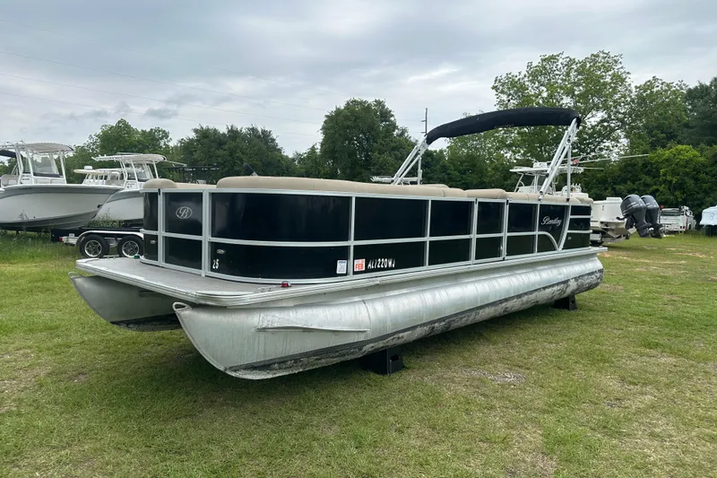 The Image of 2021 Bentley Pontoons 240 CRUISE pontoon boat on grassy area, overcast sky. - 0