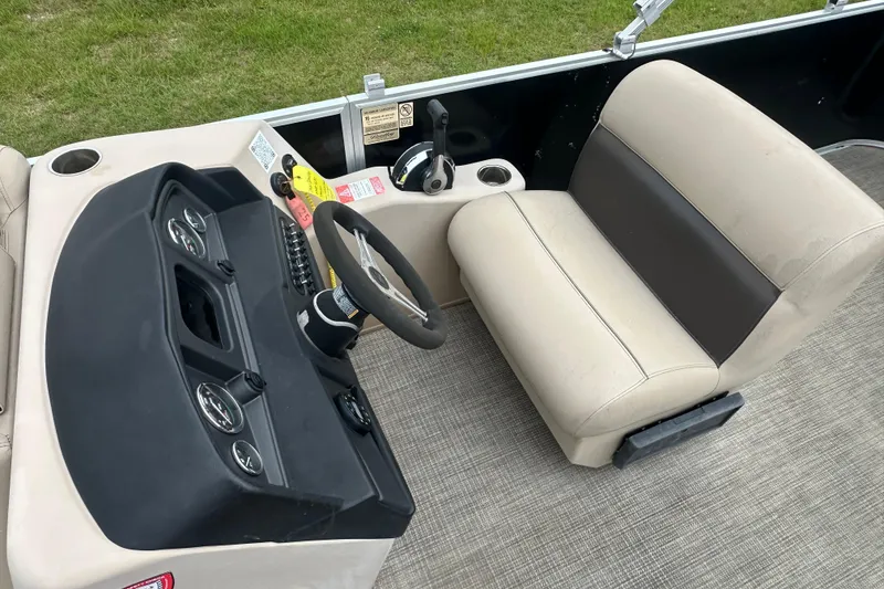Slide: The Image of 2021 Bentley Pontoons 240 CRUISE interior with steering wheel and beige seating. - 12
